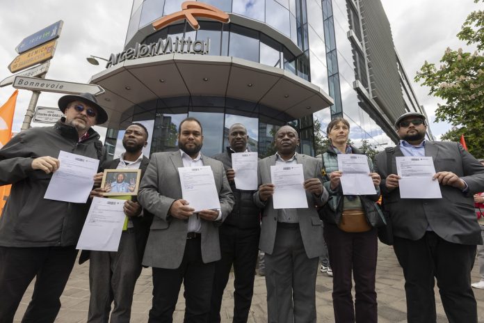 Shareholders from Fair Steel coalition members along with Defenders, prepare to enter the ArcelorMIttal AGM, to demand corporate accountability from ArcelorMittal on their repeated backtracking of their commitments towards people and planet, outside the A